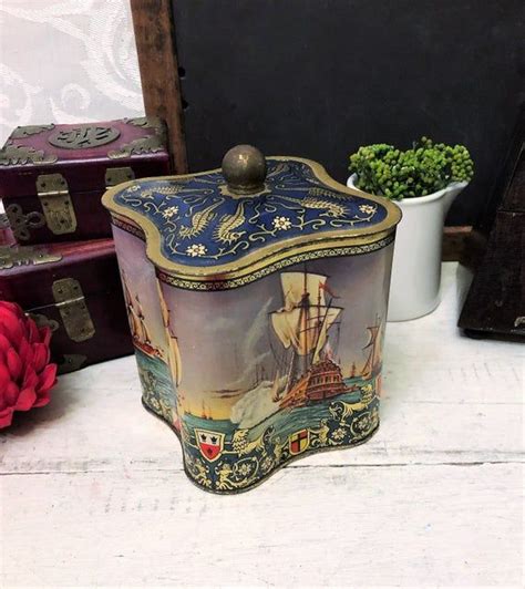 Vintage small metal box with coat of arms on the lid 